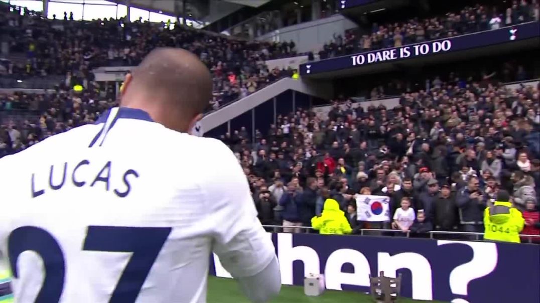 Lucas Moura celebrates with his baby son after scoring a hat-trick against Huddersfield